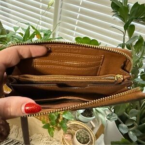 Brown Michael Kors wallet with wristlet attachment.